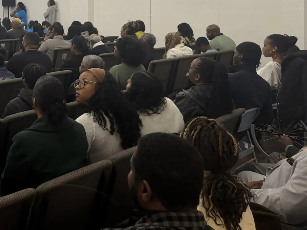 Members of the Greater Harvest Fellowship church family seated together during worship